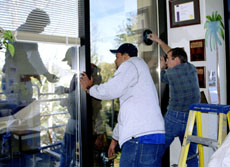 Employees of Crasto Glass company repair the window in student press adviser Liz Scott’s office last Friday. The window was broken by a bullet about two years ago during the Christmas holidays.