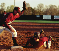 David Griener, biology freshman, slides into third during a game versus Mobile. 