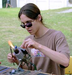 Glass artist, Andrew Pollack fashions glass during the Gaia Fest on Monday afternoon in the Residential Quad. The Loyola Green Club sponsored the event, which included food, music and crafts. The festival was held in celebration of Earth Day.