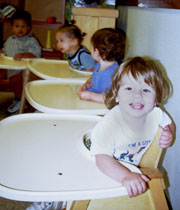 A toddler sits in a highchair at the Whelan Children’s Center.