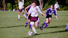 Lisa Handschumacher, biology junior, prepares to pass the ball against Spring Hill College at the ’Fly Sept. 13.  The game was the home opener for the Wolfpack, but the team went on to lose, 4-0.