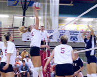 Marketing sophomore Shannon LaHaie goes up for the kill as Suzi Ruiz, history junior, and management sophomore Laurie Cacioppo look on.