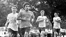 Mike Gulotta, history junior, and Anand Viswanathan, 2002 graduate, lead the Â´Pack as the cross country team circles the soccer fields at the Â´Fly.