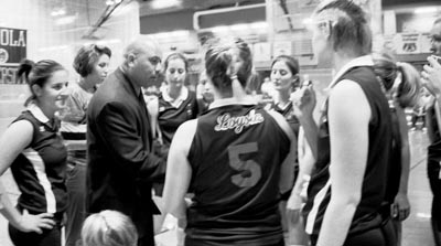 During the Spring Hill game in the Wolf Den Wednesday, the volleyball team huddles around Head Coach Greg Castillo during a time out. The ’Pack went on to win the match in five games.