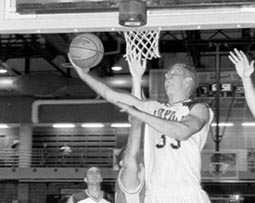 Eric Schulze, biology sophomore, goes up for a shot under the basket against the Pensacola Christian defense in the Den.  The ’Pack went on to win, 70-69, to improve its record to 2-5 with its second straight win.