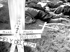 Protestors participate in a die-in at the gates of Fort Benning in Georgia on Sunday as part of the larger protest of the former School of the Americas. Several Loyola students traveled to Georgia for the protest.