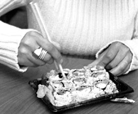 Daniella Cagol tries the cream cheese, salmon and celery sushi from the C-store. Odd combinations of ingredients add to the flavor which is a staple of the popular, expensive dish that is prepared cooked or raw.