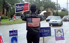A Mary Landrieu supporter waves a sign Saturday, trying to persuade motorists to vote for Landrieu in Louisiana’s U.S. Senate race. Landrieu garnered 46 percent of the vote, enough to take the lead but not enough to avoid a runnoff with Suzanne Haik Terrell.