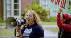 Clare Davis-Wheeler, English/environmental studies senior at Tulane, leads a protest against the war with Iraq on Tuesday afternoon.  The protestors marched from the Palm Quad to Tulane’s Pocket Park, where several speakers gathered.