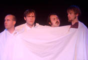 Matt McMullen, James Asmus, Rick Malphrus, and Tom Mackey, pictured from left to right, impersonate the presidents of Mount Rushmore. Draped in a sheet, the four Boxaganga members depict their vision of the four Mount Rushmore presidents as roommates having a “group meeting.”