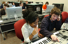 Sonali Fernando, music business freshman, and Stephen Breaux, music business sophomore, fine tune their musical recording in the G4 lab in the library.