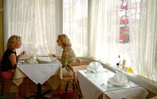 Maple Street Cafe dinners (from left to right) Colleen McLeod and Elizabeth Smither are having lunch at one of the restaurant’s quant tables near the window looking out on Maple Street.