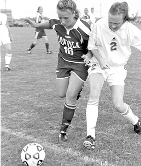 Biology/pre-med freshman Lindsey Diak aggressively pursues the ball despite intense pressure form the badgering defense at NOSA Field on the Lakefront Wednesday.