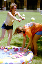 Freshmen Katie Hart and Megan Beck toss balloons at each other during Splash and Spirit.