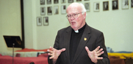 The Rev. William Byron, S.J., interim university president, speaks to a group of students in the music school Nov. 10. Byron told the audience that he was saddened that racist and discriminatory acts could happen at Loyola and called the incidents "outrageous."