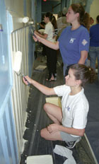 Communications junior Mary Anders, standing, and sociology junior Kathleen Goodrich paint at Bell School as part of this yearÂ´s Wolves on the Prowl. The event is just one among many charitable community programs that LoyolaÂ´s student organizations sponsor throughout the year. Many of the volunteer efforts take place around the holiday season.