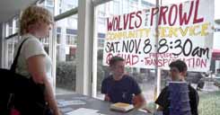 Erin Balster, music education junior, chats with Matt Smith, math junior, and Karl Weis, political science junior, as they man the Â´Wolves on the ProwlÂ´ sign-up table.