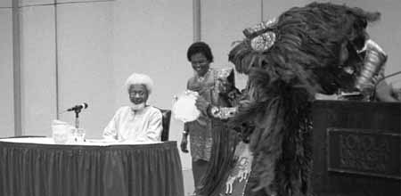 Wole Soyinka uses a Nigerian prop to help explain one of his points in Wednesday nightÂ´s lecture. Soyinka was at Loyola to attend the U.S. premier of his play, Camwood on the Leaves.