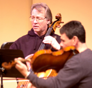 Allen Nisbet and Bruce Owen rehearse for their upcoming string quartet performance.