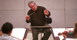 Dean Angeles conducts the Loyola Chamber Orchestra for their Spring recital. The chamber includes violins, violas, cellos, and string basses only.