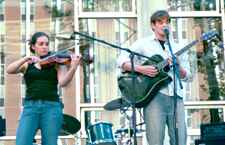 David Thies, guitarist, and Amanda Wuerstlin, violinist, perform in front of the Danna Center during a Friday UPB party.