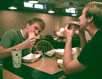 Freshmen Tim Nebel, religious studies, and Lee Attaway, general studies, chow down on sandwiches. 