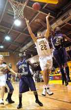 Freshman Luke Zumo goes up for a shot against Arkansas Baptist at Xavier on Saturday as a defender tries to swat the ball away. Zumo scored 12 points in LoyolaÂ´s 59-49 victory. The Â´Pack is 3-1 this season.