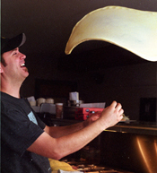 Warren Chapoto, tosses dough at his recently opened pizza joint, Slice.