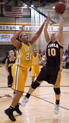 Summer Fiedler, visual graphics junior, tries to grab the basketball away from a Xavier defender.  Loyola lost 74-64 after leading in the half.