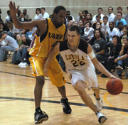 Freshman guard Luke Zumo dribbles past a Xavier defender Wednesday night in the Den.  The Â´Pack lost 69-60.  Loyola has lost six games in a row.