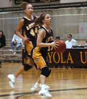 Point guard and womenÂ´s basketball captain Joelle Bordelon, sociology senior, makes a play with the basketball in the Den.  Bordelon scored her 1000th career point with the Wolfpack on Saturday against Belhaven.