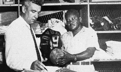 Sidney Â´TigerÂ´ Wade (right) at work in a Loyola locker room.  Wade, athletic trainer at Loyola for 39 years, will be inducted into the Sports Hall of Fame.