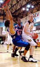 James Olivard, marketing junior, defends the ball against Tougaloo defenders Sat. night in the Den.