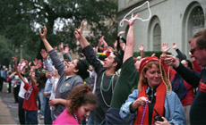 Carnival-goers reach for throws from the Krewe of CarrolltonÂ´s floats at a parade on St. Charles Avenue last Saturday.  The parades continue until Mardi Gras Day.  Carnival-goers are encouraged to use discretion along the parade routes.