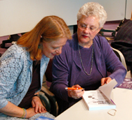 Sue Rosser signs her book, Breaking Through the Glass Ceiling for Susanne Dietzel, head of the WomenÂ´s Studies Department. Rosser, dean of the Ivan College of Science at Georgia Institute of Technology spoke Tuesday about the problems facing women in the field of science.