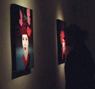 A gallery visitor examines a painting by Dawn Black last Saturday night.