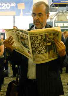 A commuter reads a copy of the Â´Evening StandardÂ´ newspaper reporting the terror bomb explosions across London, while waiting for a train to get home, at Euston Station in central London, Thursday July 7, 2005. Four blasts rocked the London subway and tore open a packed double-decker bus during the morning rush hour Thursday, sending bloodied victims fleeing in the worst attack on London since World War II. At least 40 people were killed, U.S. officials said, and more than 390 wounded in the terror attacks.