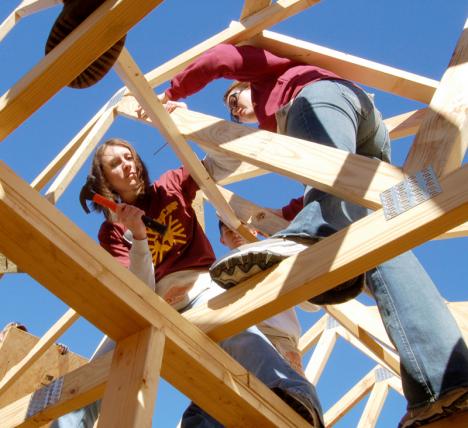 Nicole Thibodeaux, communications junior, and Ashley Christianson work on a roof for Habitat for Humanity. The Habitat event was part of Loyola Cares Day, a LUCAP-organized event focused on service to the community.