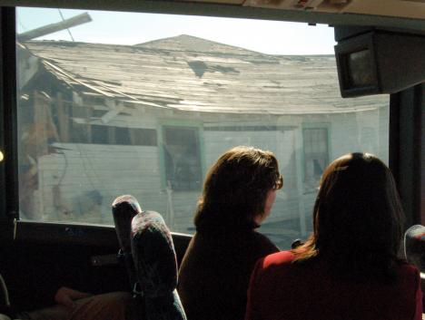 Bus tour participants view a house destroyed by Hurricane Katrina. The tour, guided by Environmental Communications Chairman Robert Thomas, traveled to three levee breaches and toured neighborhoods most affected by the hurricane.