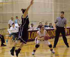 Communications junior Kiely Schork pump fakes a Spring Hill defender Monday at the Den. Loyola defeated Spring Hill 56-46.