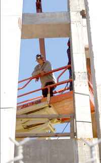 Lester Buckle, a construction worker, stands atop scaffolding on the Broadway campus. The School of LawÂ´s new building is expected to be completed in fall 2007.