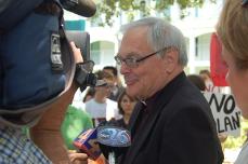 The Rev. John Callahan, S.J., answers questions from local media after stepping outside before Friday's meeting.