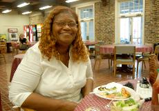 Tina Dunbar, owner of Dunbar's Creole Cooking takes a moment of rest on the opening day of the restaurant's new location on Pine Street.