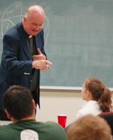 The Rev. David Boileau, S.J., discusses economic and union issues at an economics club meeting Tuesday afternoon.