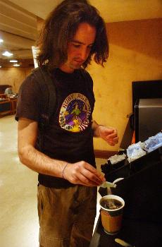 Music performance senior Thomas Goicoechea fixes his coffee in the Underground Wednesday.