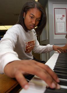 Atoyia Scott strikes the ivories outside the Orleans Room. The music performance freshman moonlights as a basketball player.