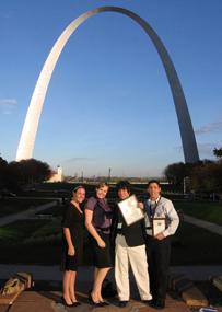 Senior staff writer Coleen OLear, Life & Times editor Nicole Wroten, sports editor Ramon Vargas and sports editor Michael Nissman display the Pacemaker Award under the Gateway Arch.