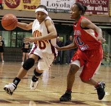 Guard Trenell Smith, psychology sophomore, blows past a Tougaloo defender. Smith had 9 points and seven assists to help power a dominating performance authored by the Lady Wolfpack.