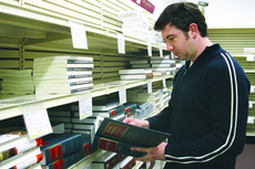 Matt Berger, third-year law student, looks for a used copy of one of his required books in the Loyola bookstore.