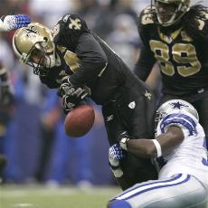 Saints return specialist Michael Lewis absorbs a hit against the Dallas Cowboys last week. This Sunday, when his team won the NFC South, he had another career memory against the Redskins - albeit a bittersweet one.